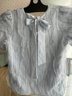 Wavy-patterned top with a bow tied at the back