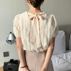Wavy-patterned top with a bow tied at the back